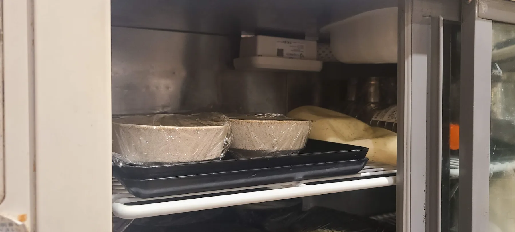 CropWatch sensor monitoring a commercial refrigerator full of prepared food in a restaurant kitchen